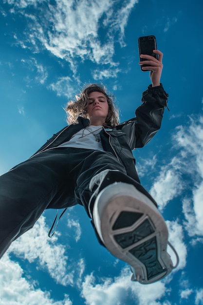 Portrait of young person celebrating world photography day with camera device